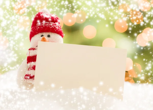 Snowman with Blank White Card Over Abstract Snow and LIght — Stock Photo, Image