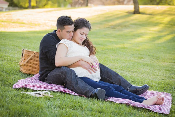 Pareja hispana embarazada en el parque al aire libre —  Fotos de Stock