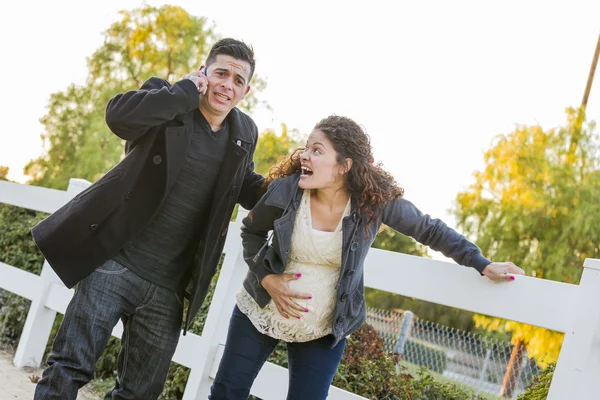 Pregnant Woman In Pain While Husband Uses Cell Phone Outside — Stock Photo, Image