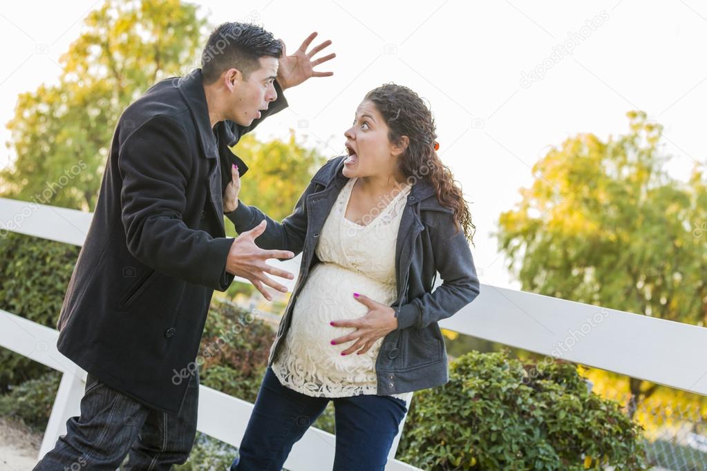 Stunned Excited Pregnant Woman and Husband with Hand on Belly
