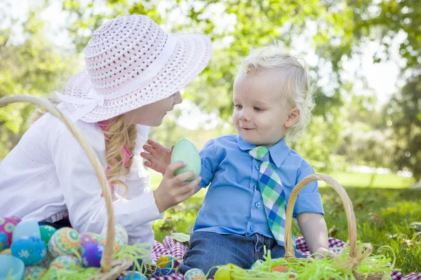 Lindo joven hermano y hermana disfrutando su Pascua huevos fuera — Foto de Stock