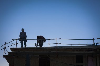 İnşaat İşçileri siluet çatı üzerinde