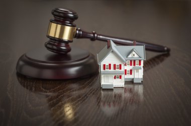 Gavel and Small Model House on Table clipart