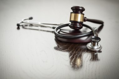 Gavel and Stethoscope on Reflective Table clipart