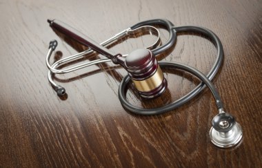 Gavel and Stethoscope on Reflective Table clipart