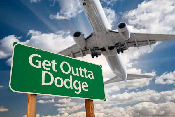 Get Outta Dodge Green Road Sign Dramatic Clouds Sky — Stock Photo, Image