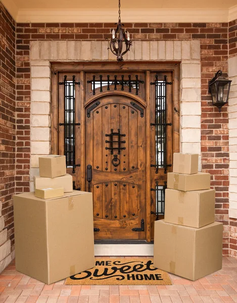 Several Packages Sitting Home Sweet Home Welcome Mat Front Door — Stock Photo, Image
