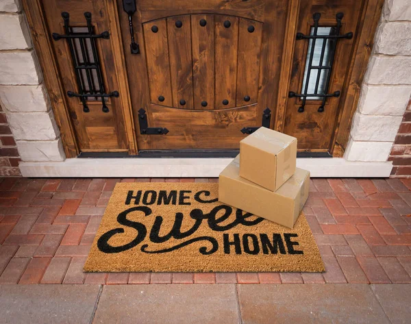 Small Packages Sitting Home Sweet Home Welcome Mat Front Door — Stock Photo, Image