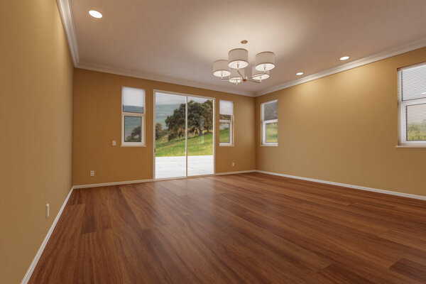Newly Remodeled Room of House with Finished Wood Floors, Moulding, Dark Tan Paint and Ceiling Lights.