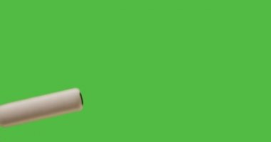 Male Hand Using Paint Roller To Cover Entire Green Screen from Left to Right.