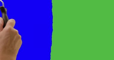 Female Hand Using Paint Roller To Cover Entire Screen From Green Screen to Blue Screen.
