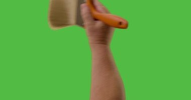 Male Using Paint Brush Three Strokes Across Green Screen. Strokes can be used together or independently top middle and bottom.