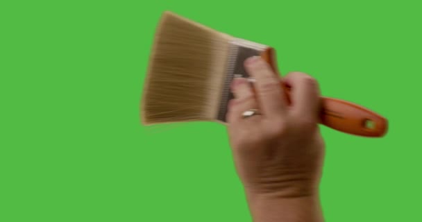 Male Applying Two Paint Brush Strokes Green Screen — Stock Video