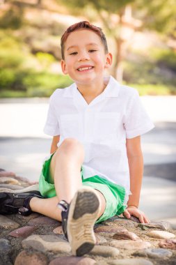 Outdoor portrait of a mixed race Chinese and Caucasian boy.