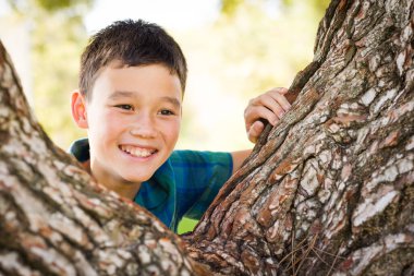 Outdoor portrait of a mixed race Chinese and Caucasian boy.