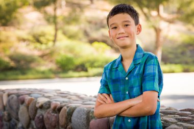 Outdoor portrait of a mixed race Chinese and Caucasian boy.