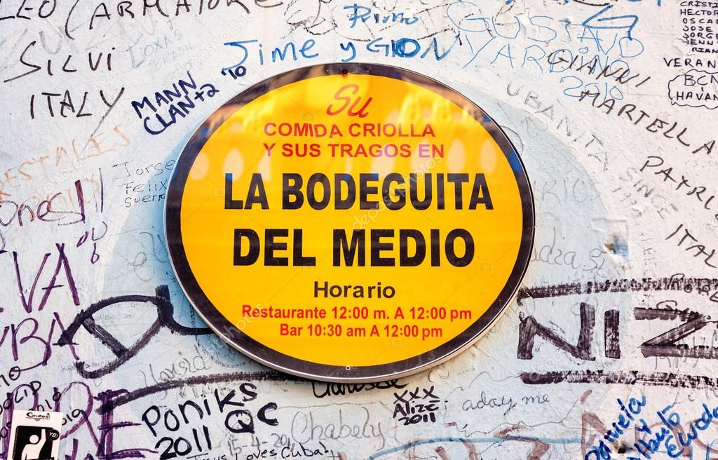 Sign with graffitti at La Bodeguita del Medio in Havana