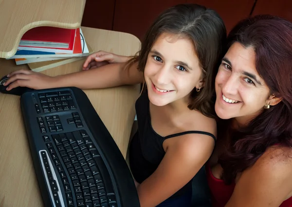 Madre hispana y su hija trabajando en una computadora — Foto de Stock