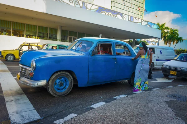 Un viejo auto americano recogiendo a un pasajero en La Habana —  Fotos de Stock