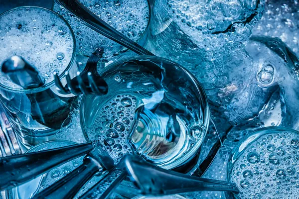 Cutlery being washed with water and detergent — Stock Photo, Image