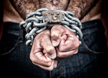 Detail of the chained hands of an adult man clipart