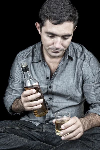 Drunk and depressed hispanic man with a black background — Stock Photo, Image