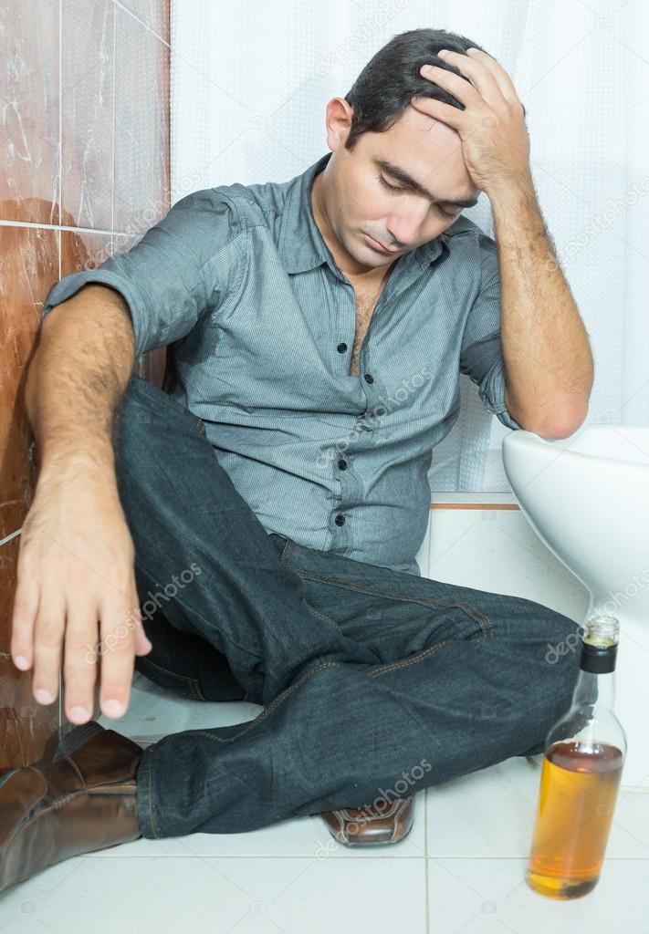 Drunk latin man sleeping on the toilet