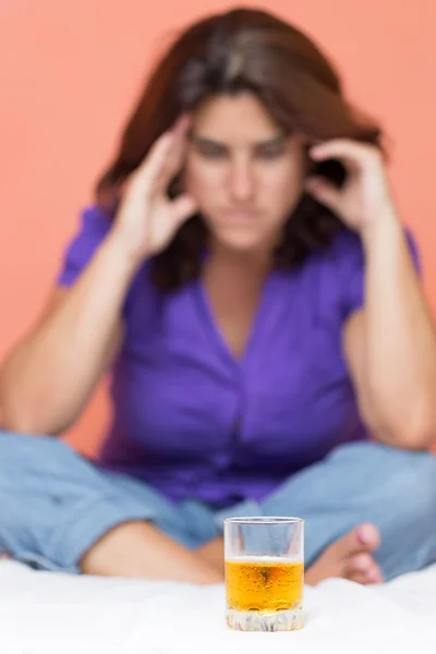 Alcohol addict looking at a glass of whiskey — Stock Photo, Image