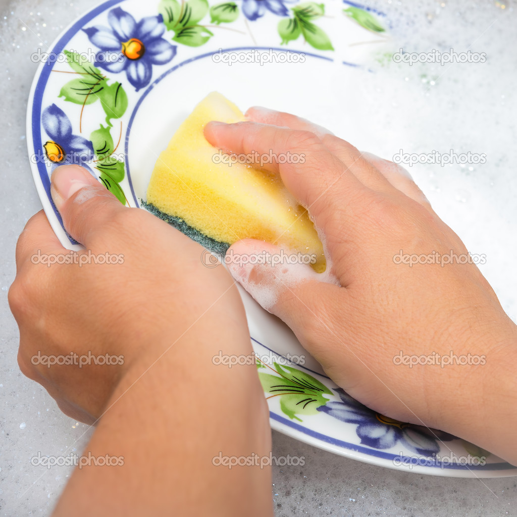 Hands washing the dishes