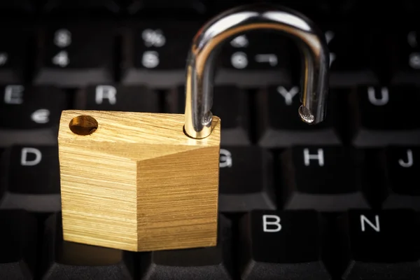 Open padlock on a black computer keyboard — Stock Photo, Image