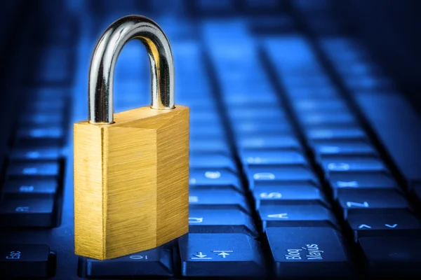 Locked padlock om a glowing blue computer keyboard — Stock Photo, Image