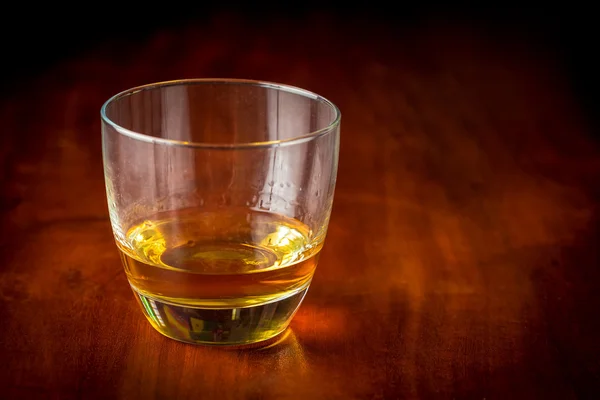 Whisky or rum on a wooden table — Stock Photo, Image