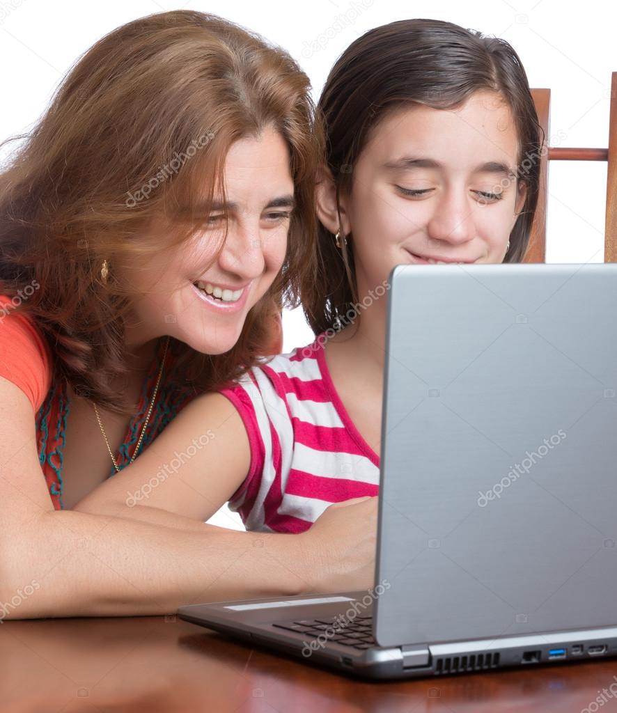 Teenager and her mother browsing the web