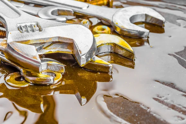 Wrenches, nuts and bolts stained with motor oil — Stock Photo, Image