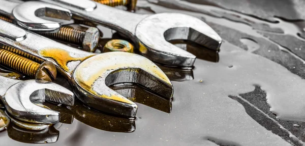 Wrenches, nuts and bolts stained with motor oil — Stock Photo, Image