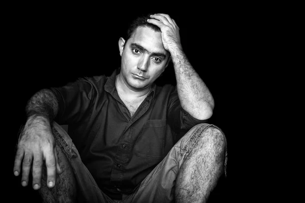 Stressed and worried young man sitting on the floor — Stock Photo, Image