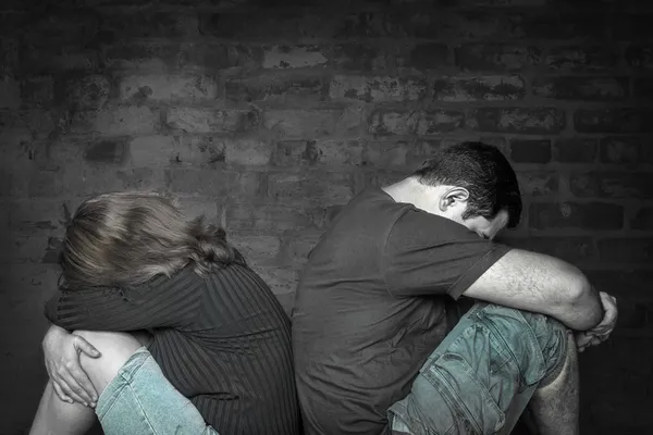Young couple angry at each other sitting back to back — Stock Photo