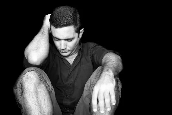 Sad and stressed young man sitting on the floor — Stock Photo, Image