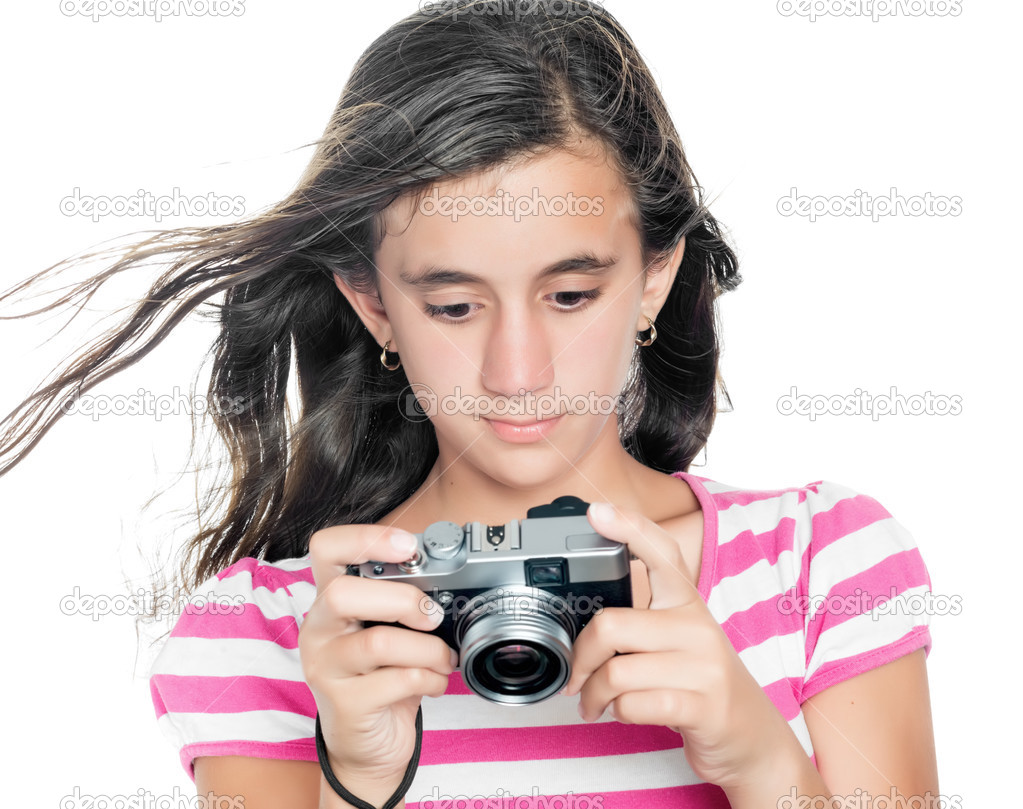 Young girl looking at images taken on a compact camera