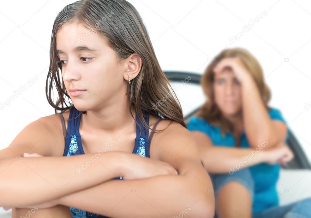 Worried and thoughtful teenage girl with her mother