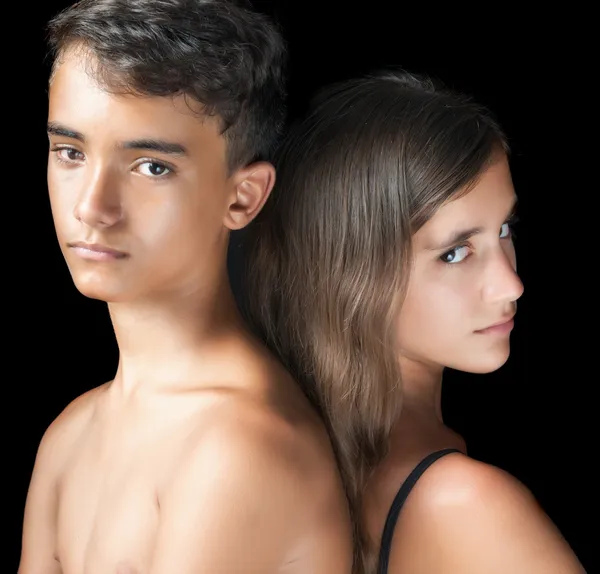 Unhappy young teen couple on a black background — Stock Photo, Image