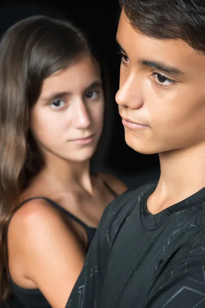 Sad teenagers - boy and girl - isolated on black — Stock Photo, Image