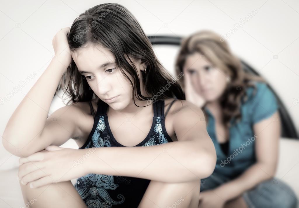 Sad teenage girl and her worried mother