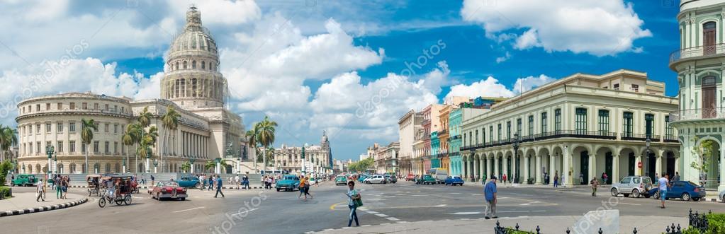 HAVANA,CUBA - MARCH 17, 2014 : Street scene with people and old cars next to the Capitol buildiing in Old Havana