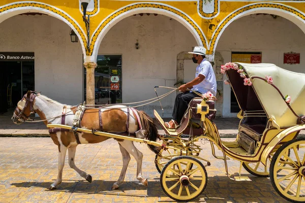 IZAMAL,MEXICO - AUGUST 3,2022 : Horse carriage at the magical town of Izamal in Yucatan