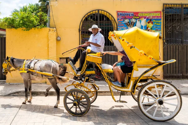 IZAMAL,MEXICO - AUGUST 3,2022 : Horse carriage at the magical town of Izamal in Yucatan