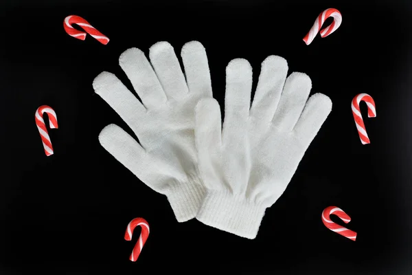 Little White Knitted Gloves Candy Canes Isolated Black Background Overhead — Stock Photo, Image