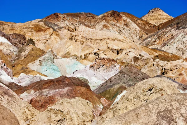 The variegated slopes of Artists Palette in Death Valley, California. Various mineral pigments have colored the volcanic deposits found here. — Stock Photo, Image