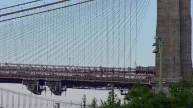 East River üzerindeki Brooklyn Köprüsü New York 'tan gün batımında Aşağı Manhattan' ın rıhtımından izlendi