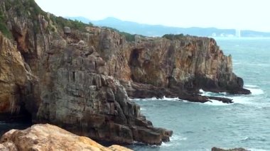 Sandanbeki Cliffs, Shirahama, Wakayama Prefecture, Japan. Sandanbeki consists of three steep cliffs with a large network of caves at water level.